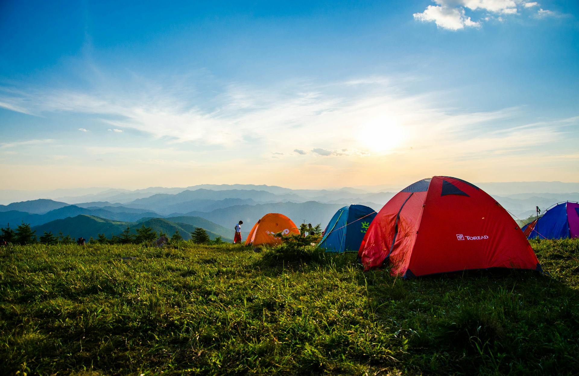 Dawn over mountain camping tents — about Munn Supply Co outdoor outfitter